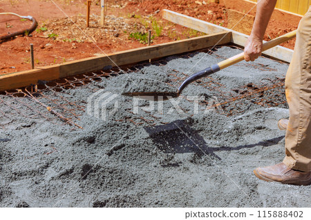 During construction work, ground is leveled filled with fine gravel stones for purpose of pouring concrete into foundation house 115888402