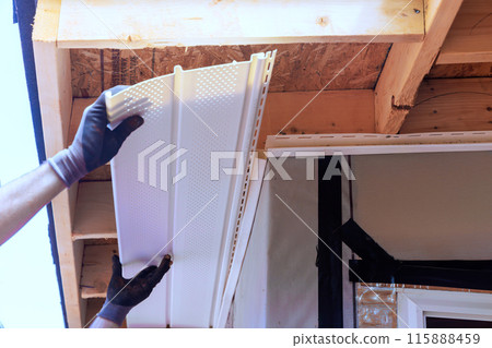 Nailing upvc soffit boards to roof rafters on ceiling house Nailing upvc soffit boards to roof rafters on ceiling house 115888459
