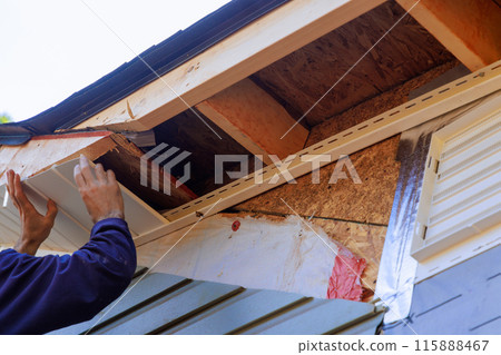Under facia roof of house, vinyl white uPVC soffit boards have been installed along roofline. 115888467