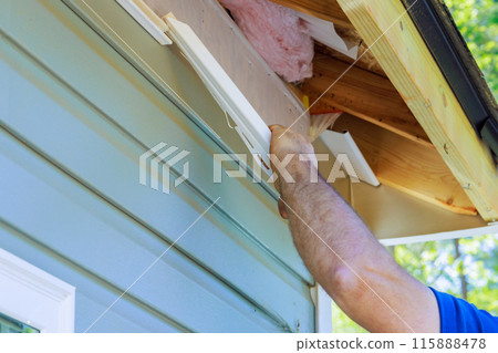 In course of house exterior remodel, damaged plastic siding is replaced In course of house exterior remodel, damaged plastic siding is replaced 115888478
