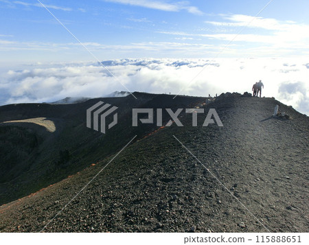 Climbers climbing the outer rim of Mt. Iwate 115888651
