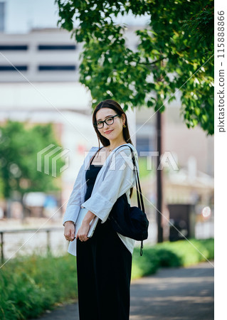 Young woman walking with a computer 115888866