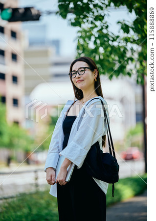 Young woman walking with a computer Young woman walking with a computer 115888869