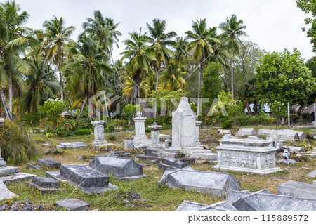 Ancient gray gravestones at La Digue island cemetery Ancient gray gravestones at La Digue island cemetery 115889572