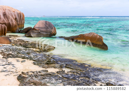 Summer landscape photo with rocks on the Anse Union beach Summer landscape photo with rocks on the Anse Union beach 115889582