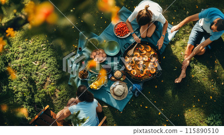 Family Enjoying Homemade Paella Outdoors Family Enjoying Homemade Paella Outdoors 115890510