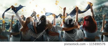 Banner. Fans, dressed in blue, passionately cheer and gesture towards field, creating electrifying atmosphere inside stadium. 115890576