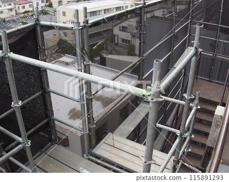 Scaffolding for an apartment building undergoing renovation work Scaffolding for an apartment building undergoing renovation work 115891293