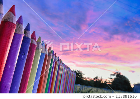 A beautiful image of a school wall in coloured pencils against a blushing evening sky A beautiful image of a school wall in coloured pencils against a blushing evening sky 115891610