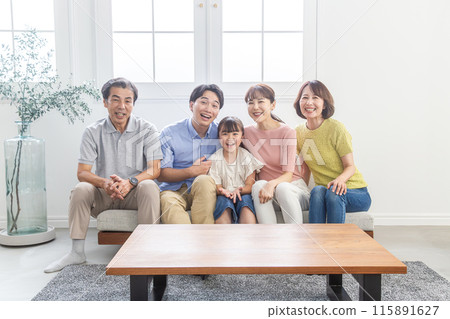 Three-generation family relaxing in the living room Three-generation family relaxing in the living room 115891627
