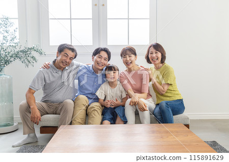 Three-generation family relaxing in the living room Three-generation family relaxing in the living room 115891629