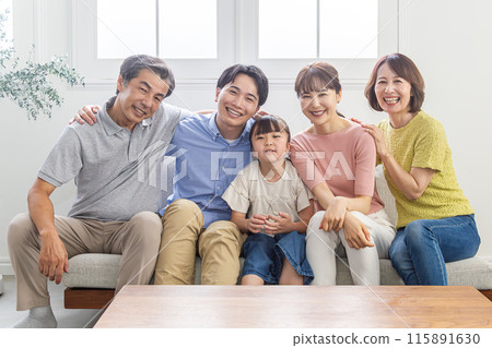 Three-generation family relaxing in the living room Three-generation family relaxing in the living room 115891630