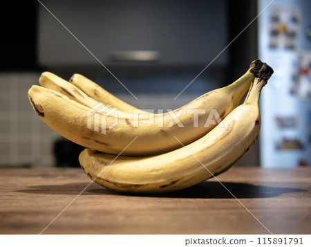 bunch of bananas on a wooden table. High quality photo 115891791