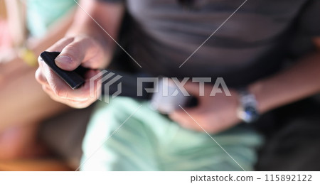 Man fixes his seat belt in airplane closeup Man fixes his seat belt in airplane closeup 115892122