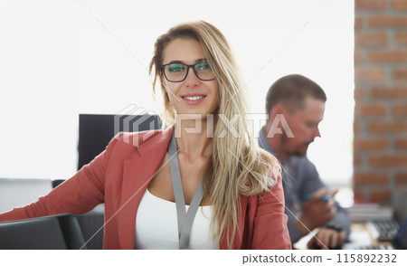 Portrait of smiling businesswoman at workplace in office Portrait of smiling businesswoman at workplace in office 115892232