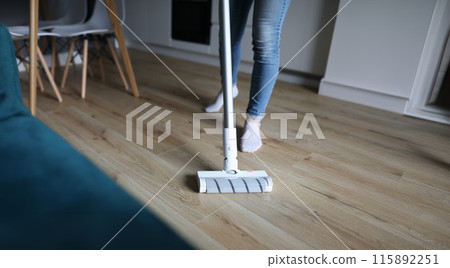 Woman washes floor with mop. Services of cleaning companies 115892251