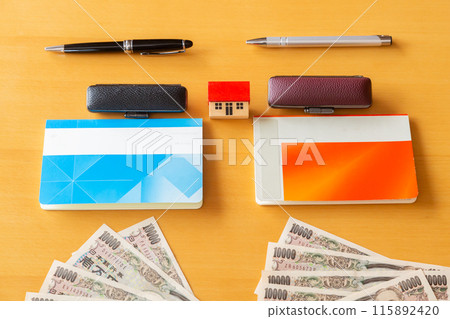 Two bankbooks and stamps, 10,000 yen bills and a house Money image Two bankbooks and stamps, 10,000 yen bills and a house Money image 115892420