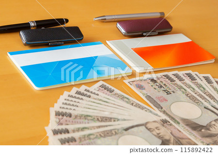 Two bankbooks and stamps, 10,000 yen bills and a house Money image 115892422