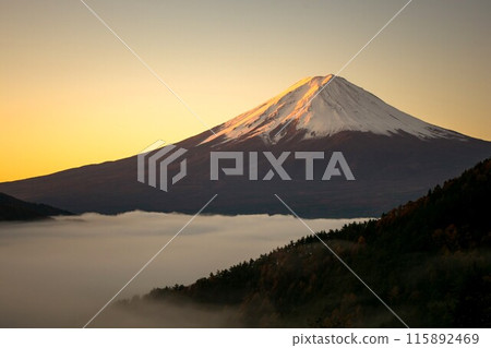 Snow-capped Mt. Fuji and sea of clouds seen from Fujimi Bridge in the early morning, a spectacular view illuminated by the morning sun, horizontal composition 115892469