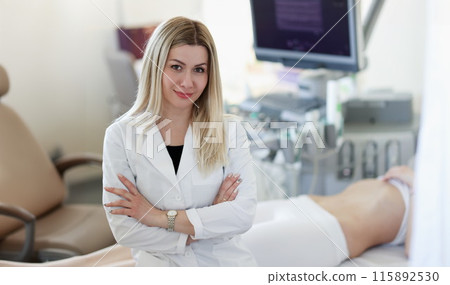 Portrait of doctor of ultrasound diagnostics on background of patient Portrait of doctor of ultrasound diagnostics on background of patient 115892530