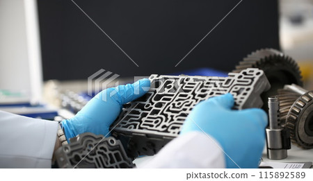 Man in gloves holds car gearbox closeup Man in gloves holds car gearbox closeup 115892589