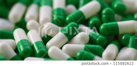 Large number of pharmaceutical white-green tablets closeup Large number of pharmaceutical white-green tablets closeup 115892621