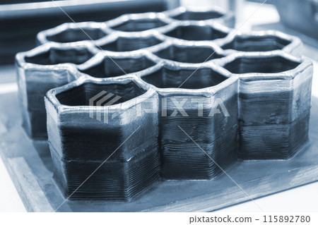 Object printed by 3D printer from metal. Additive manufacturing solution. Object created on 3Dprinter from melting metal thread. 3D Metal Printing. Metal additive manufacturing Object printed by 3D printer from metal. Additive manufacturing solution. Object created on 3Dprinter from melting metal thread. 3D Metal Printing. Metal additive manufacturing 115892780