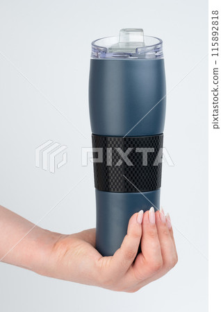 Blue thermo flask in hand 115892818
