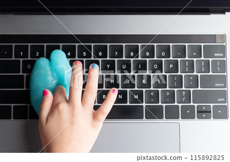 Hand cleaning keyboard above top view 115892825