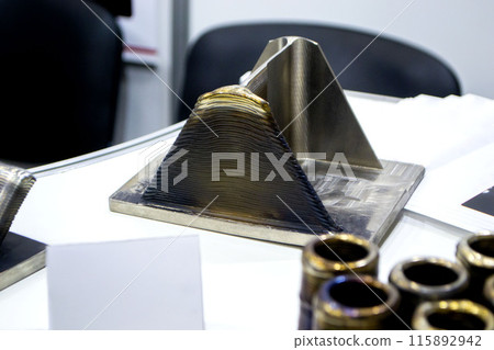 Object printed by 3D printer from metal. Additive manufacturing solution. Object created on 3Dprinter from melting metal thread. 3D Metal Printing. Metal additive manufacturing Object printed by 3D printer from metal. Additive manufacturing solution. Object created on 3Dprinter from melting metal thread. 3D Metal Printing. Metal additive manufacturing 115892942