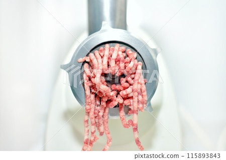 minced meat production process in an electric meat grinder 115893843