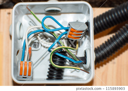 open electrical distribution box with connected wires 115893903