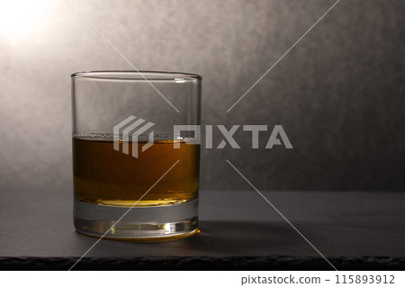 glass goblet with whiskey on a dark background glass goblet with whiskey on a dark background 115893912