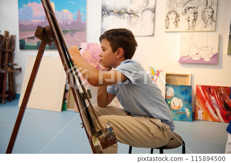 Kids have art class, drawing, painting with teacher in workshop. Kids have art class, drawing, painting with teacher in workshop. 115894500
