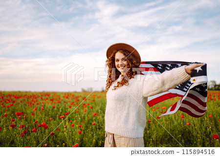 Young woman hold waving american USA flag in in the poppy field. Independence Day, 4th July. Young woman hold waving american USA flag in in the poppy field. Independence Day, 4th July. 115894516