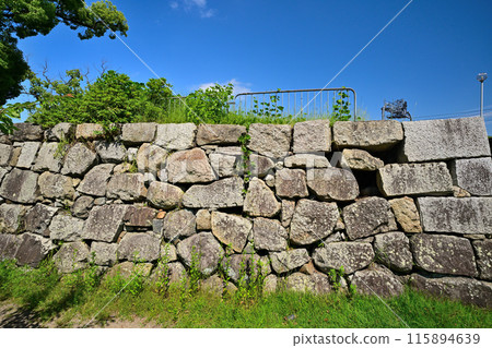 Stone walls and moat of the main citadel of Yodo Castle in Yamashiro Province 115894639