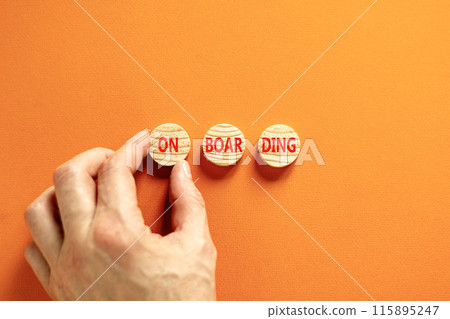 Onboarding success symbol. Concept word Onboarding on wooden circles. Beautiful orange table orange background. Businessman hand. Business onboarding success concept. Copy space. 115895247