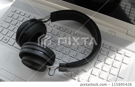 International Communication And Online Meeting. Headphones On White Keys Of Laptop Keyboard 115895426