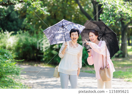 A middle-aged woman walking with a parasol 115895621