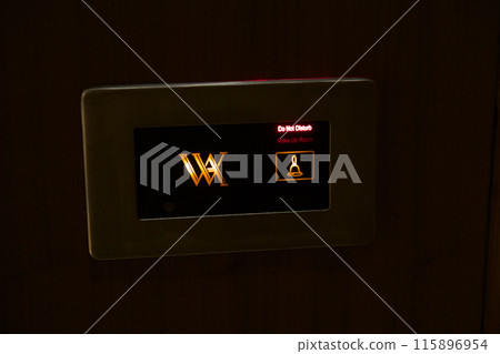 RAS AL KHAIMAH, UNITED ARAB EMIRATES - JUNE 11, 2019: Doorbell of a luxurious hotel room in a five-star hotel RAS AL KHAIMAH, UNITED ARAB EMIRATES - JUNE 11, 2019: Doorbell of a luxurious hotel room in a five-star hotel 115896954