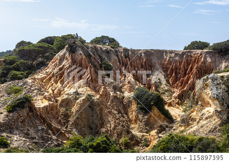 Praia da Marinha Beach among rock islets and cliffs seen from Seven Hanging Valleys Trail, Algarve, Portugal Praia da Marinha Beach among rock islets and cliffs seen from Seven Hanging Valleys Trail, Algarve, Portugal 115897395
