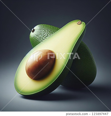 Ripe avocado halved to expose brown seed with vibrant green flesh and textured skin on a neutral grey backdrop. 115897447