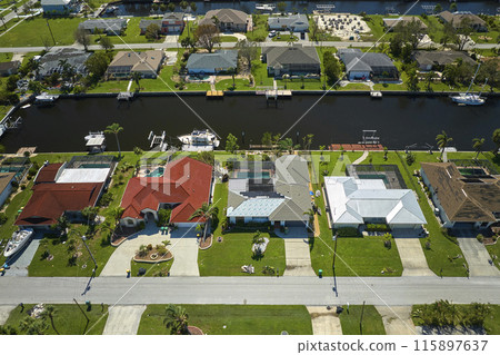 Damaged home rooftops after hurricane Ian in Florida coastal residential area. Consequences of natural disaster Damaged home rooftops after hurricane Ian in Florida coastal residential area. Consequences of natural disaster 115897637