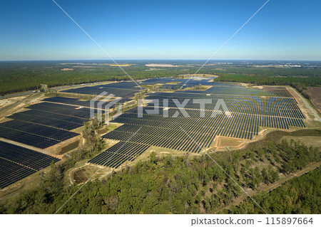 Aerial view of large sustainable electrical power plant with rows of solar photovoltaic panels for producing clean electric energy. Concept of renewable electricity with zero emission 115897664