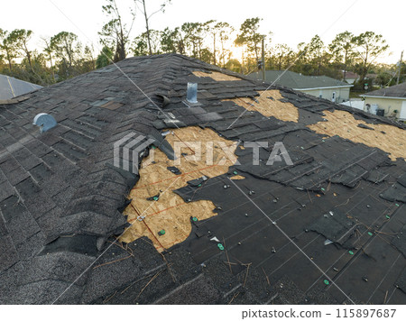 Natural disaster and its consequences. Hurricane Ian destroyed house roof in Florida residential area 115897687