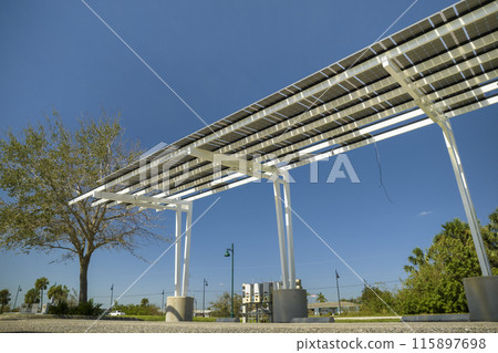 Wind damage to solar panels installed over parking lot canopy shade for parked cars for effective generation of clean energy Wind damage to solar panels installed over parking lot canopy shade for parked cars for effective generation of clean energy 115897698