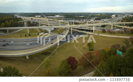 Aerial view of american freeway intersection with fast moving cars and trucks. USA transportation infrastructure concept 115897738