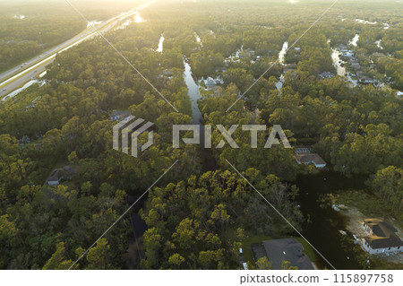 Heavy flood with high water surrounding residential houses after hurricane rainfall in Florida residential area. Consequences of natural disaster 115897758