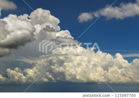 Blue sky with white summer rain clouds. Colorful summer landscape 115897780