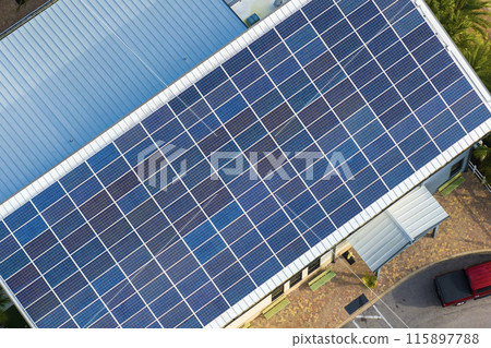 Solar rooftop on commercial center in Florida. Photovoltaic panels for producing of clean ecological electrical energy in city urban area. Concept of autonomous building Solar rooftop on commercial center in Florida. Photovoltaic panels for producing of clean ecological electrical energy in city urban area. Concept of autonomous building 115897788